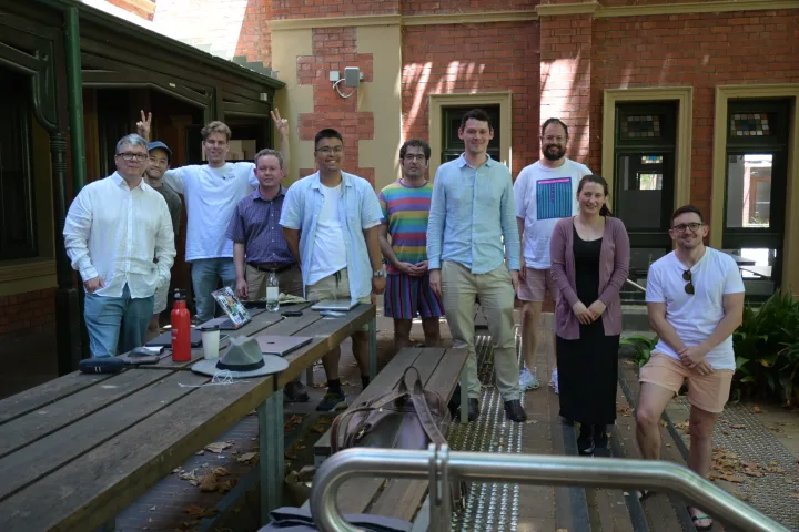 Community members gathered beside a picnic table in Melbourne.