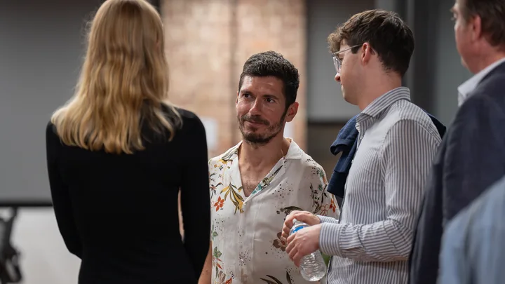Guests talking together after the presentations.